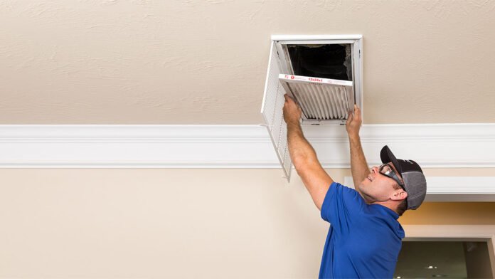 Person Cleaning Air Duct